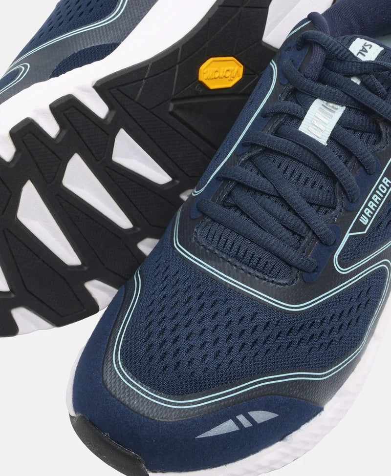 Navy running shoes with white soles on a white background